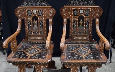 A pair of 19th Century Walnut Italian Chairs in the style of Adriano Brambilla lavishly inlaid with