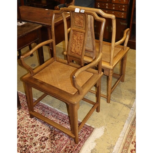 A pair of Chinese Ming style hardwood elbow chairs, with can...