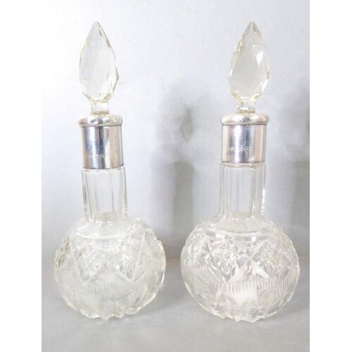 A pair of cut-glass silver-mounted scent bottles; each with ...