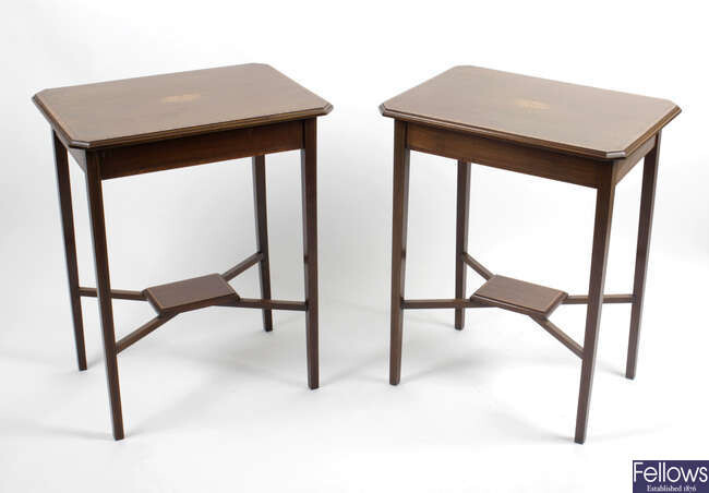 A pair of early twentieth century mahogany side tables, raised upon square block tapered supports.