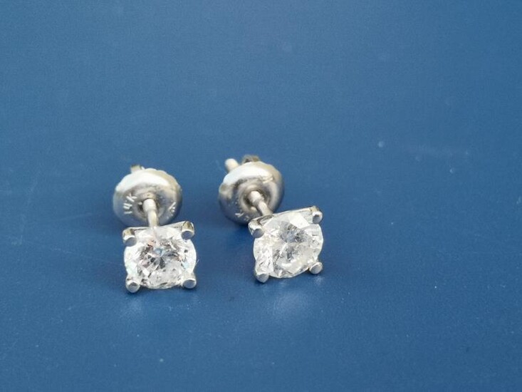 A pair of modern diamond stud earrings, the four-claw...