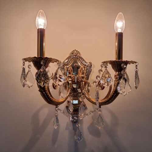 A pair of Italian opulent brass two-branch wall sconces ador...