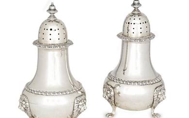 A pair of silver sugar casters, London, c.1961, Harrods, the baluster-shaped bodies raised on paw feet with lion mask shoulders, gadrooned banding to bodies and rims, 14.5cm high, total weight approx. 12.6oz (2)