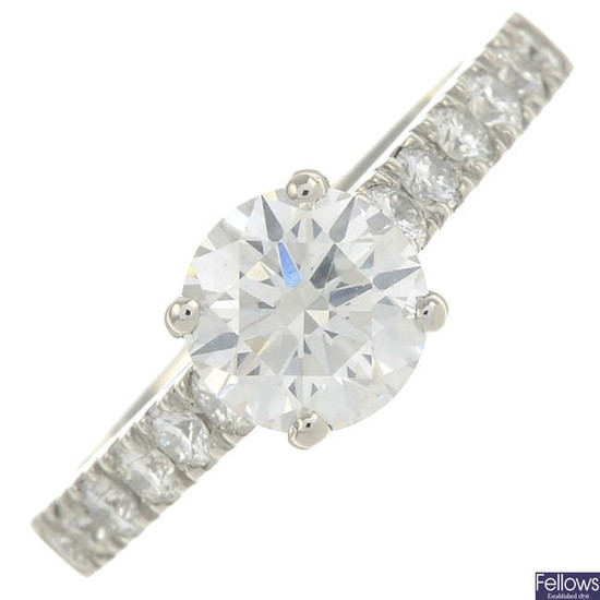 A platinum brilliant-cut diamond single-stone ring, with diamond line shoulders.