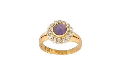 A purple star sapphire and diamond cluster ring