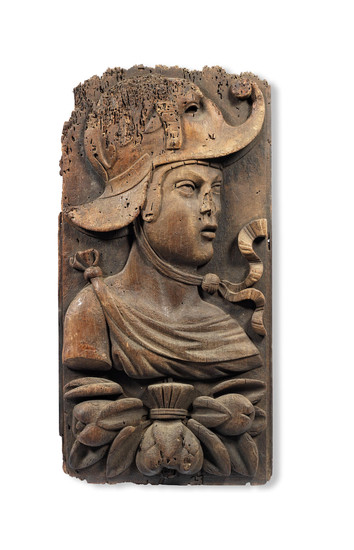 A rare and large carved walnut panel, French, circa 1520-40, carved with an 'antique' bust