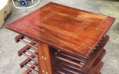 A rosewood coffee table, the top inlaid with two bands...