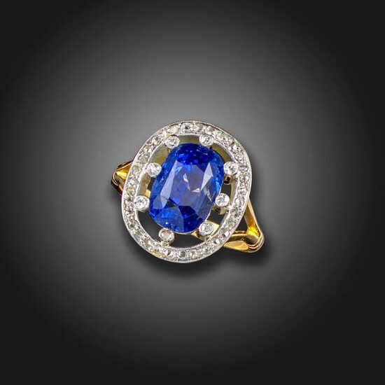 A sapphire and diamond cluster ring, the cushion-shaped sapphire weighs...