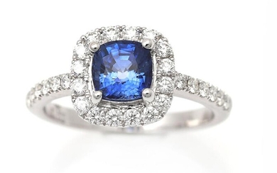 NOT SOLD. A sapphire and diamond ring set with a cushion-cut sapphire encircled by numerous brilliant-cut diamonds, mounted in 18k white gold. Size app. 53.5 – Bruun Rasmussen Auctioneers of Fine Art