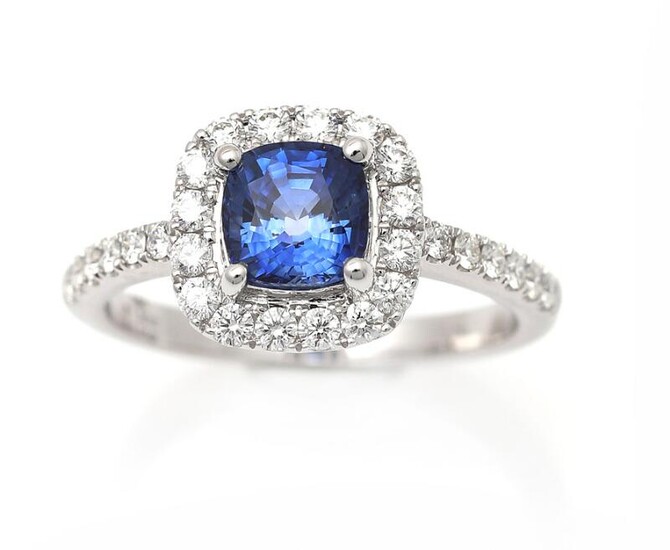 NOT SOLD. A sapphire and diamond ring set with a cushion-cut sapphire encircled by numerous brilliant-cut diamonds, mounted in 18k white gold. Size app. 53.5 – Bruun Rasmussen Auctioneers of Fine Art