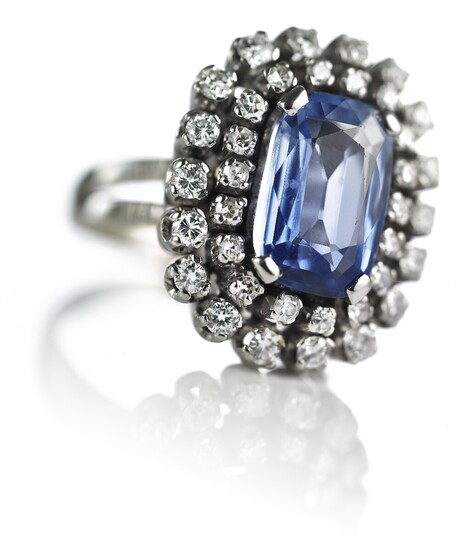 A sapphire and diamond ring set with a natural Ceylon sapphire weighing app. 3.50 ct. encircled by numerous diamonds weighing a total of app. 2.00 ct. Size 53.