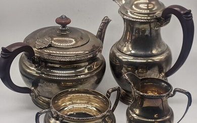 A silver tea set comprising of a teapot, waterpot,...