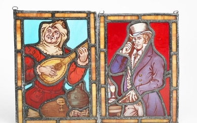 A small Aesthetic Movement stained glass Minstrel panel, rectangular depicting a minstrel playing a mandolin, and another stained glass panel of a Victorian gentleman in top hat and tails wearing a monocle, unsigned, 27 x 18.5cm. (2)