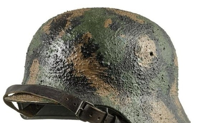 A steel helmet with later camouflage paint, 1970s