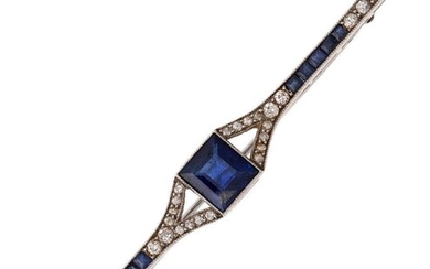 A synthetic sapphire and diamond brooch, c.1910, centring on a step-cut synthetic sapphire to a millegrain bar set with calibre-cut synthetic sapphires and single-cut diamonds, length 6.4cm, Mappin & Webb case