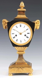 AN EARLY FRENCH BRONZE AND ORMOLU URN SHAPED MANTEL CLOCK th...