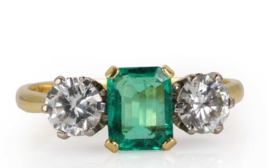 An 18ct gold Colombian emerald and diamond three stone ring