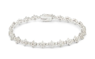 An 18ct white gold and diamond bracelet, set with a...
