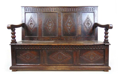An 18th century and later oak settle, the diamond carved...