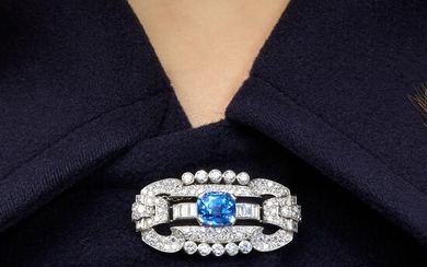 An Art Deco brooch set with diamonds and a 5,96 carat cushion shape sapphire. The mount in platinum. In a fitted case. Gross weight:...