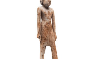 An Egyptian wood figure of a man