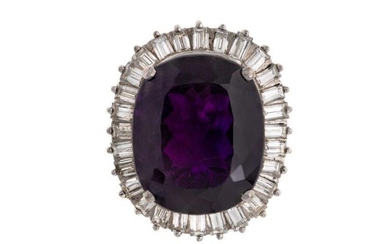An amethyst and diamond ring, claw set with an oval mixed-cut amethyst, framed by baguette diamonds, British hallmarks, ring size K