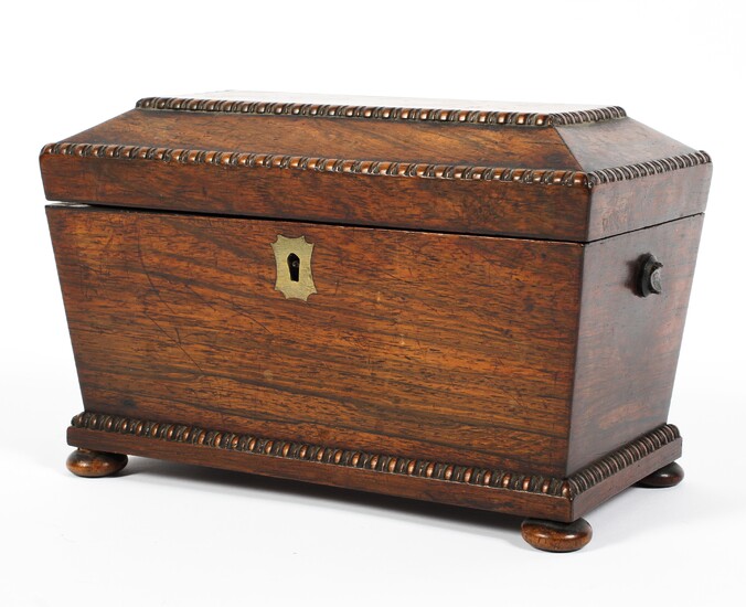 An early 19th century rosewood tea caddy, of sarcophagus form