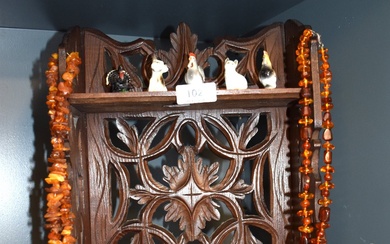 An early 20th Century oak folding display stand and a selection of ornaments including wade