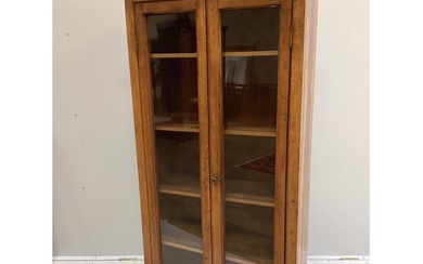An early 20th century oak and mahogany narrow bookcase with ...
