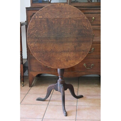 Antique English George III oak circular tilt top table, on t...