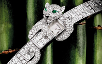 CARTIER. A LADY’S IMPRESSIVE AND VERY RARE 18K WHITE GOLD, DIAMOND AND EMERALD-SET BRACELET WATCH