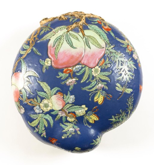 CHINESE FAMILLE ROSE PORCELAIN PEACH-FORM COVERED BOX Raised peach branch and butterfly decoration on a powder blue ground. Four-cha...