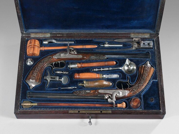 Box containing a pair of percussion pistols by Lepage Moutier: blued octagonal barrels signed on the upper sides: "Lepage Moutier arqer à Paris"; calibre 12 mm, rifled; front plates engraved with foliage and rinceaux, double stecher trigger tail; iron...