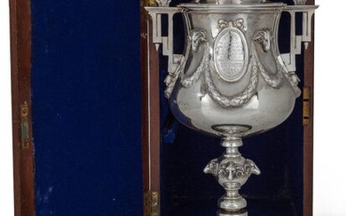 Cycling interest. A Victorian silver 'Brighton Bicycling Club' trophy cup, London, 1864, Edward Ker Reid, in wooden case, the trophy designed with angular twin handles to rounded body chased with laurel swags suspended from applied ram heads...