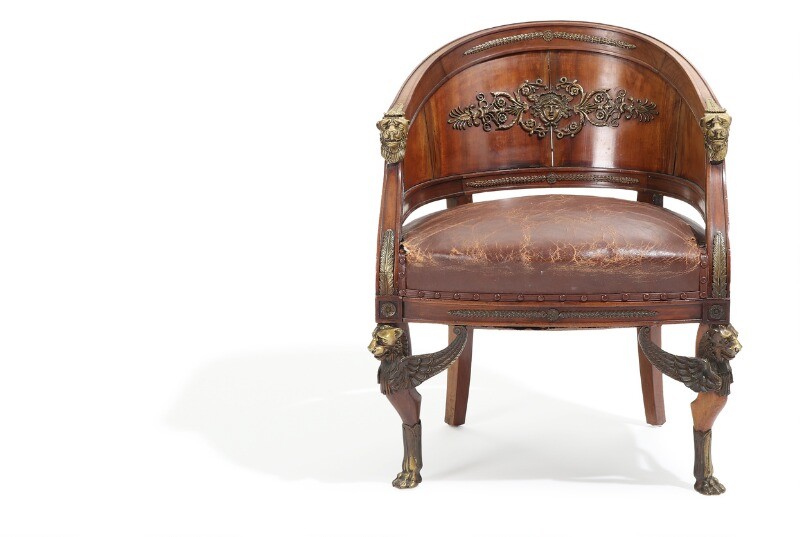 “Fauteuil gondole”. A French 19th century bronze mounted mahogany Empire style armchair. Richly decorated with lions and foliage.