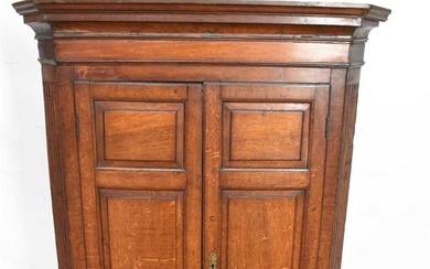 George III oak hanging corner cupboard with panelled doors