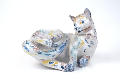 Helge Christoffersen (Danish, 1925-1965), a tin-glazed earthenware cat, polychrome decorated with foliage on a white ground, with blue monogram 'HC' and paper label to base, 14cm high, 31cm wide