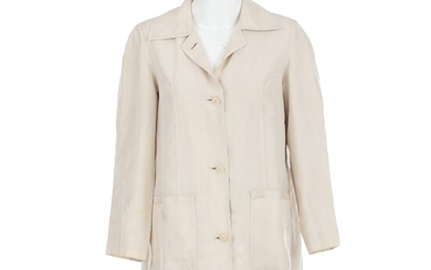 SOLD. Hermès: A beige jacket made of silk with a collar, buttons on the front,...
