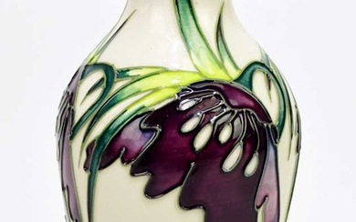 NICOLA SLANEY FOR MOORCROFT; a slender vase decorated with flowers...