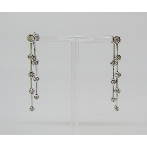 Pair of articulated 18ct white gold drop earrings set with g...