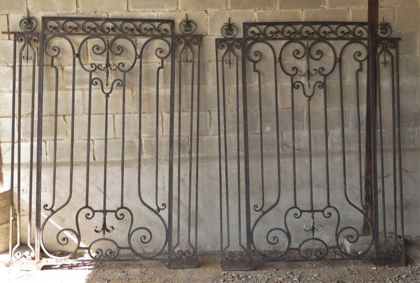 Pair of wrought-iron grills decorated with scrolls and interlacing.