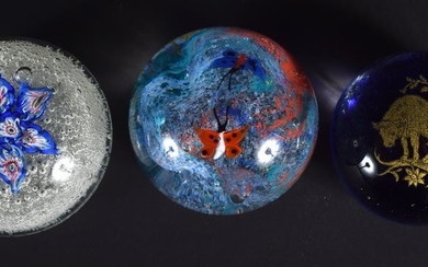 THREE GLASS PAPERWEIGHTS in various forms and sizes.