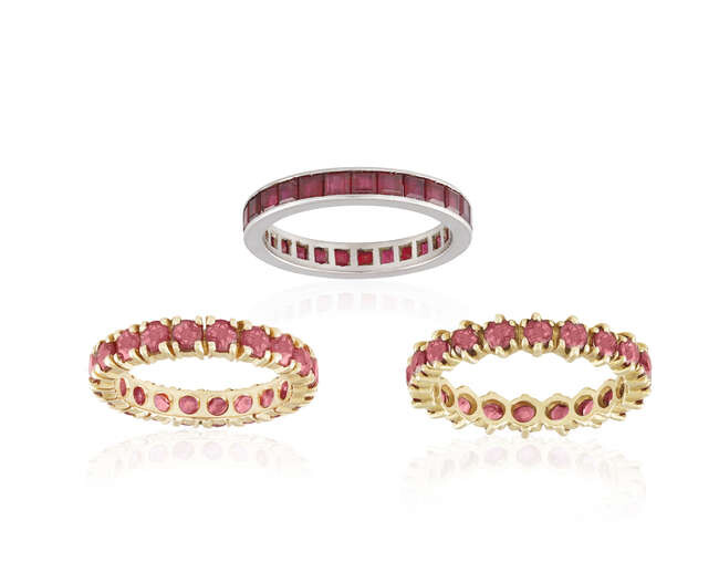 THREE RUBY ETERNITY RING, one set with a...