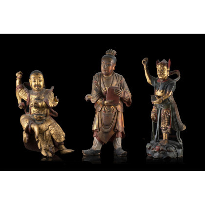 Three carved wood sculptures, partly gilted and painted, of deities (defects and losses) China, late Qing dynasty (h. max 59...