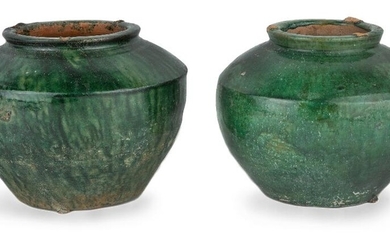 Two Chinese green-glazed pottery jars, Han dynasty, each with similar carinated shoulders and thick circular rims with flat base covered in dark green glaze, 11cm high. (2) Provenance: Estate of the late designer Anthony Powell (1935 – 2021). 漢...