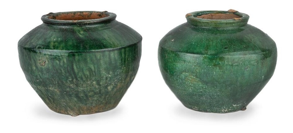 Two Chinese green-glazed pottery jars, Han dynasty, each with similar carinated shoulders and thick circular rims with flat base covered in dark green glaze, 11cm high. (2) Provenance: Estate of the late designer Anthony Powell (1935 – 2021). 漢...