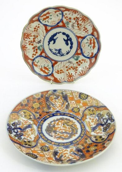 Two Oriental plates, one decorated with panelled detail
