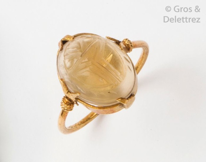 Yellow gold ring with a citrine engraved with...
