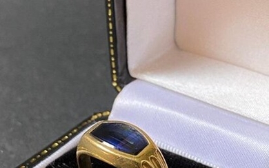 Yellow gold ring with a synthetic blue stone...