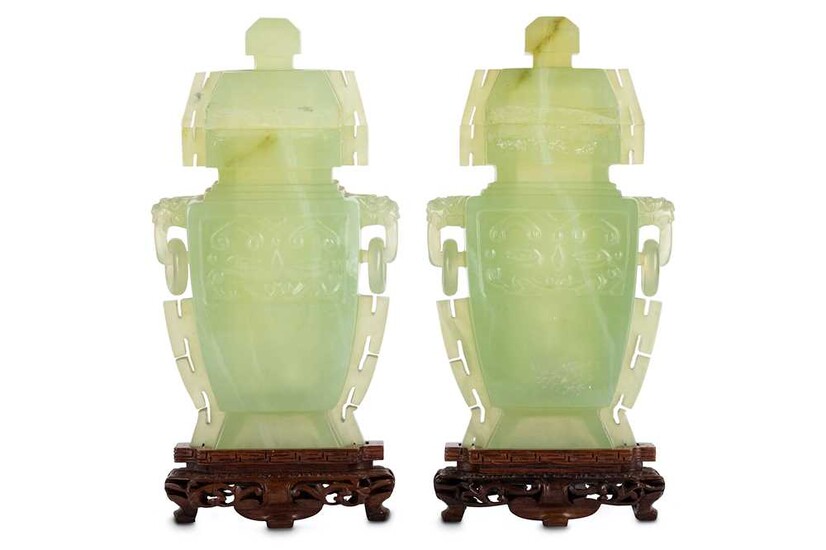 A pair of Chinese serpentine vases and covers.